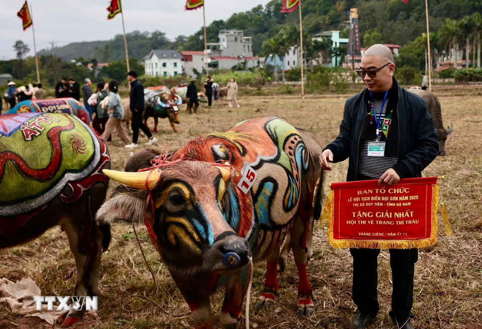 Hoạ sỹ nhận giải Nhất cuộc thi. (Ảnh: Trần Việt/TTXVN)