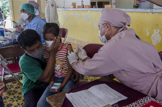 Nhân viên y tế tiêm vaccine phòng COVID-19 cho trẻ em tại Yogyakarta, Indonesia. (Ảnh: THX/TTXVN) Hướng đi mới trong chiến lược chống dịch bệnh COVID-19 ảnh 2