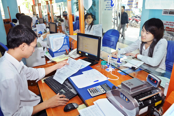 Giao dịch tại Kho bạc Nhà nước. (Ảnh minh họa. Nguồn: tuyengiao.vn) Tỉnh Long An chú trọng thông tin dữ liệu ngành hàng, thị trường ảnh 1