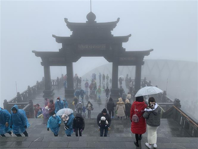 Đông đảo khách du lịch đã lên đỉnh Fansipan để chiêm ngưỡng cảnh tuyết rơi. (Ảnh: Quốc Khánh/TTXVN) Bắc Bộ rét đậm, vùng núi cao có thể xảy ra băng giá và sương muối ảnh 1