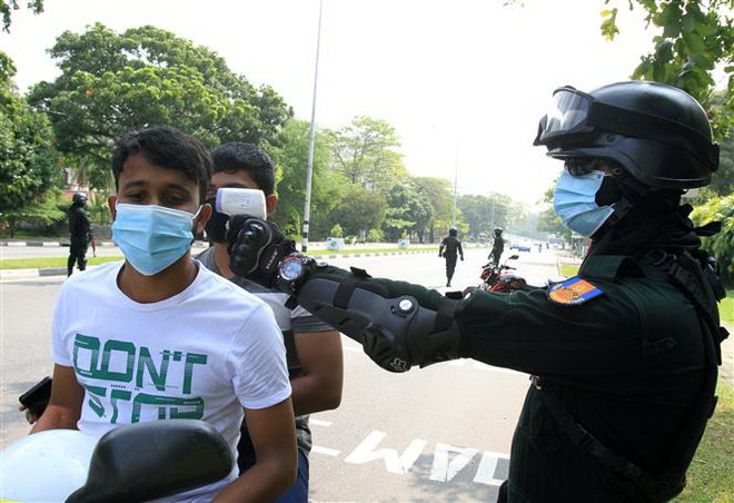 Kiểm tra thân nhiệt cho người dân nhằm kiểm soát sự lây lan của dịch COVID-19 tại Colombo, Sri Lanka. (Ảnh: THX/TTXVN) COVID-19: Thủ đô Nhật Bản ghi nhận tháng có số ca mắc cao nhất ảnh 2
