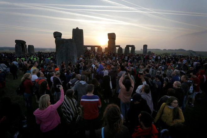 Du khách chờ Mặt Trời mọc chào đón ngày dài nhất trong năm ở Vòng tròn đá Stonehenge ngày 21/6. (Nguồn: EPA/TTXVN) Người Anh đón ngày dài nhất trong năm tại vòng tròn đá Stonehenge ảnh 2
