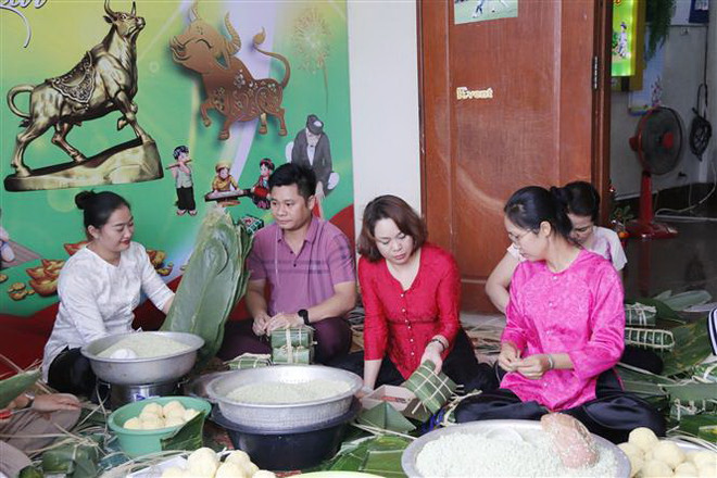 Mọi người cùng nhau trải qua những khoảnh khắc đầm ấm trong những ngày giáp Tết Nguyên đán. (Ảnh: Phạm Kiên/TTXVN) Người Việt tại Lào giúp nhau vượt qua nỗi nhớ quê hương dịp Tết đến ảnh 1