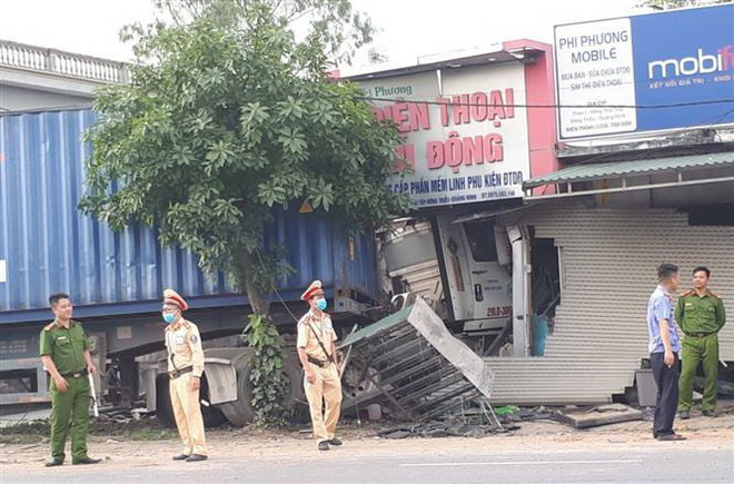 Xe container mất lái đâm gãy cột điện, lao vào cửa hàng điện thoại ảnh 1