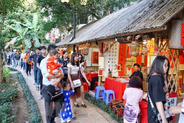 Khu vực xin chữ tại Văn Miếu-Quốc Tử Giám thu hút rất đông người dân và du khách. (Ảnh: Khánh Hòa/TTXVN phát) Những phong tục tập quán trong ngày Tết cổ truyền ở Việt Nam ảnh 3