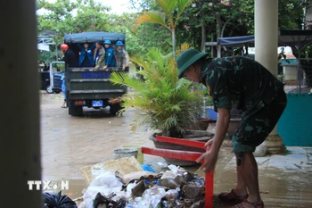 Lực lượng Sư đoàn 305, Quân khu 5 tham gia dọn dẹp vệ sinh tại một trường học ở Khánh Hòa sau ngập lụt. (Ảnh: Phan Sáu/TTXVN)