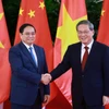 Thủ tướng Phạm Minh Chính với Thủ tướng Trung Quốc Lý Cường. (Ảnh: Dương Giang/TTXVN)