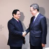 Thủ tướng Phạm Minh Chính gặp Phó Thủ tướng Thường trực Trung Quốc Đinh Tiết Tường. (Ảnh: Dương Giang/TTXVN)