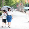 Người dân che ô khi di chuyển dưới trời nắng gay gắt. (Ảnh: Lê Đông/TTXVN)