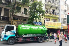 Dự án đã huy động 30 nhân sự và 5 xe hút bùn, các thiết bị chuyên dụng, bao tải cát và các vật tư, quây rào tạm để tiến hành khoanh vùng, thu gom, xử lý bùn. (Ảnh: PV/Vietnam+)