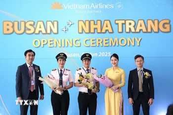 Trưởng chi nhánh Vietnam Airlines tại Hàn Quốc Nguyễn Huy Đức tặng hoa cho tổ bay chuyến bay đầu tiên. (Ảnh Khánh Vân/TTXVN)