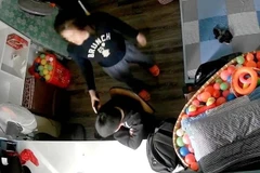 Hình ảnh video thể hiện cảnh được cho là bé trai bị mẹ kế cầm điện thoại đánh vào đầu. (Nguồn: Ảnh cắt từ clip)