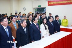 Thủ tướng Phạm Minh Chính và Phu nhân cùng các cử tri thực hiện nghi thức chào cờ, khai mạc bầu cử tại Khu vực bỏ phiếu số 21 phường Tây Hồ, thành phố Hà Nội. (Ảnh: Dương Giang/TTXVN)