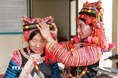 Phụ nữ người Hà Nhì vùng biên viễn Lai Châu sửa soạn trang phục đón một mùa Xuân mới. (Ảnh: Quý Trung/TTXVN)