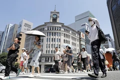 Người dân di chuyển dưới trời nắng nóng tại Tokyo, Nhật Bản. (Ảnh: Kyodo/TTXVN)
