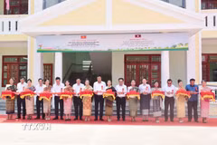 Đại biểu hai nước cắt băng khánh thành Trường Tiểu học và Trung học Hữu nghị cho Hội người Việt Nam tỉnh Salavan. (Ảnh: Xuân Tú/TTXVN)