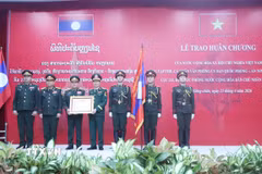 Đại tướng Nguyễn Tân Cương tặng Huân chương Độc lập của Nhà nước Việt Nam cho tập thể thuộc Bộ Quốc phòng Lào. (Ảnh: Xuân Tú/TTXVN)