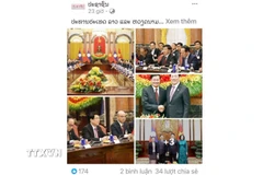 Bài viết Chủ tịch nước hai nước Việt Nam-Lào gặp song phương trên báo Pasaxon. (Ảnh: Xuân Tú/TTXVN)