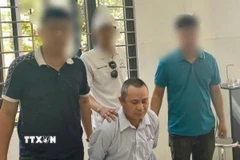 Đối tượng Võ Thế Hùng bị bắt giữ sau một ngày lẩn trốn vì hành vi "Giết người." (Ảnh: TTXVN phát)