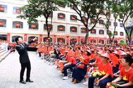 Ca sỹ Tùng Dương đã thổi bùng không khí, tình yêu nước sục sôi đến các học sinh Trường Nguyễn Siêu. (Ảnh: PV/Vietnam+)