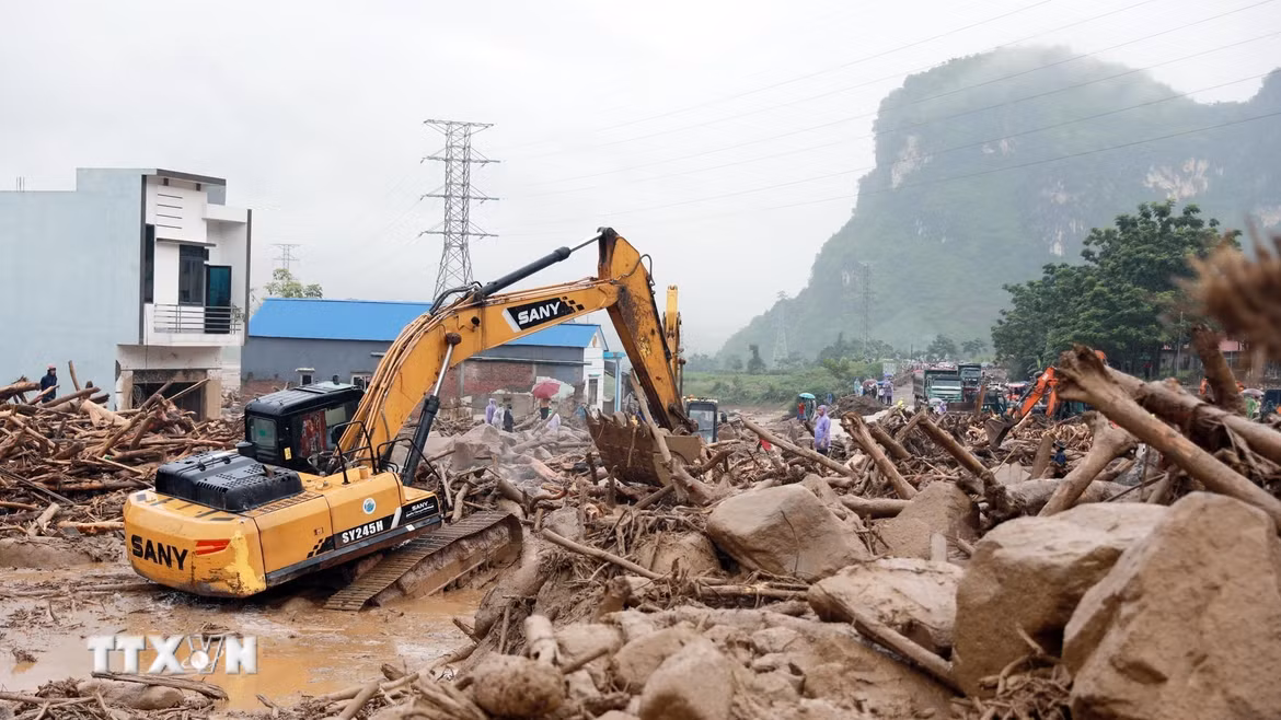 Hàng ngàn mét khối đất đá đổ tràn xuống Quốc lộ 32 đang được lực lượng chức năng nỗ lực xử lý. (Ảnh: Quý Trung/TTXVN)