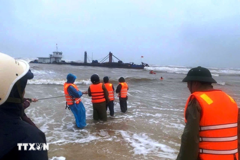 Các lực lượng tích cực ứng cứu, đưa các thuyền viên trên tàu gặp nạn vào bờ. (Ảnh: TTXVN phát)