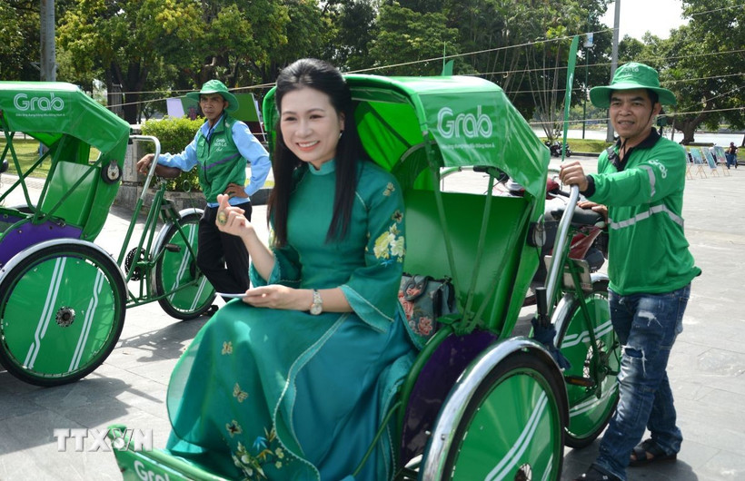Người dân trải nghiệm mô hình dịch vụ Grab Xích lô tại Huế. (Ảnh: Văn Dũng/TTXVN)