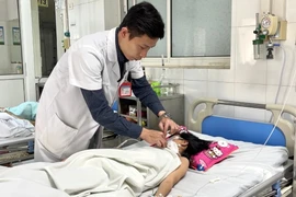 Bác sỹ theo dõi sức khỏe cho bệnh nhân. (Ảnh: PV/Vietnam+)
