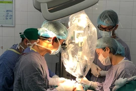 Các bác sỹ thực hiện ca phẫu thuật cho bệnh nhân. (Ảnh: PV/Vietnam+)