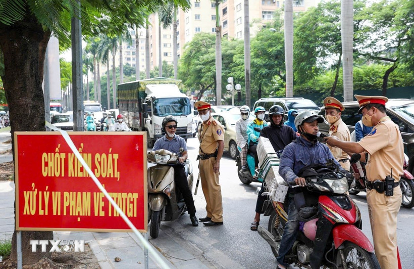 Cảnh sát Giao thông kiểm tra nồng độ cồn với người tham gia giao thông. (Ảnh: Phạm Kiên/TTXVN)