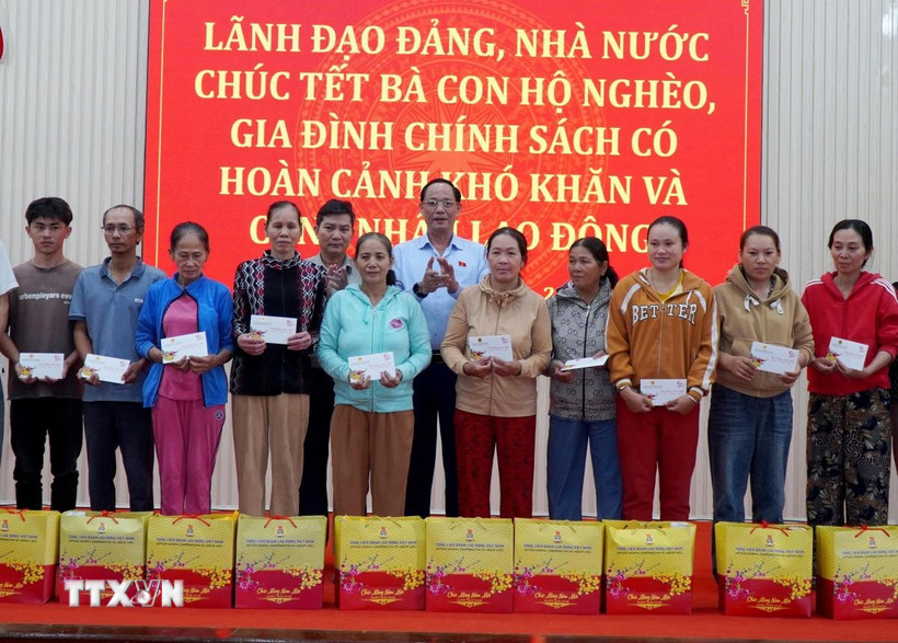 Phó Chủ tịch Quốc hội Trần Quang Phương tặng quà cho hộ nghèo, gia đình chính sách khó khăn trên địa bàn phường Đức Phổ. (Ảnh: Lê Phước Ngọc/TTXVN)