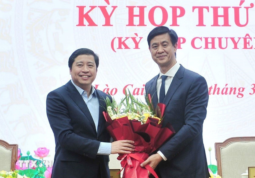 Đồng chí Dương Quốc Huy, Ủy viên Ban Chấp hành Trung ương Đảng, Bí thư Tỉnh ủy Lào Cai tặng hoa chúc mừng đồng chí Phan Trung Bá. (Ảnh: Tuấn Khôi/TTXVN)