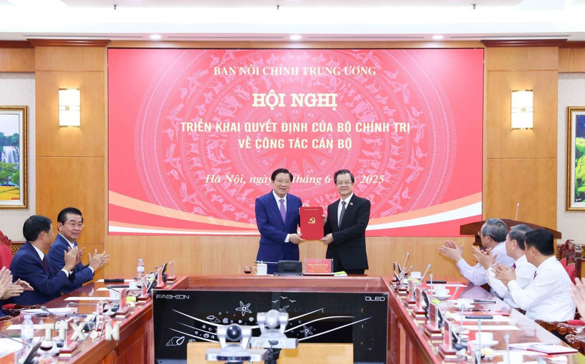 Đồng chí Phan Đình Trạc, Ủy viên Bộ Chính trị, Bí thư Trung ương Đảng, Trưởng Ban Nội chính Trung ương trao Quyết định của Bộ Chính trị cho đồng chí Lê Hồng Quang. (Ảnh: Phương Hoa/TTXVN)