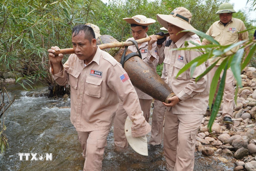 Đội cơ động của MAG di dời quả bom an toàn đến khu vực chờ hủy nổ. (Ảnh: TTXVN phát)