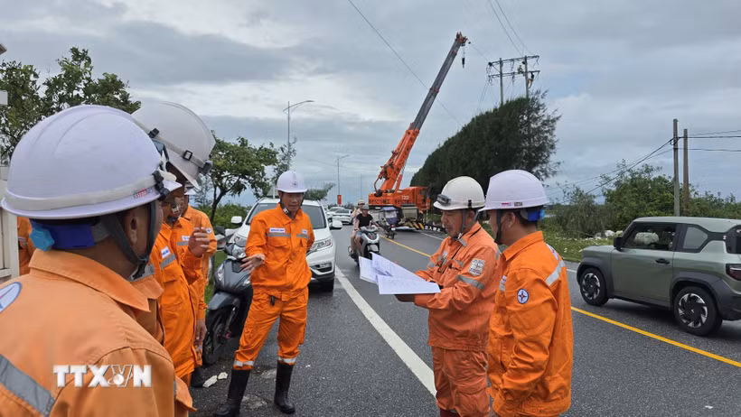 ​Lực lượng xung kích ngành điện Quảng Ninh khẩn trương đấu nối, xử lý dứt điểm các vị trí đứt dây, hư hỏng xà, sứ sau bão số 1. (Ảnh: Thanh Vân/TTXVN)