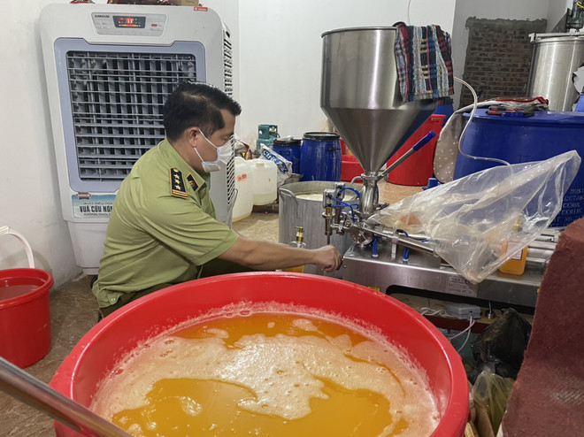 Lực lượng Quản lý thị trường Hà Nội kiểm tra cơ sở sản xuất mỹ phẩm nghi là hàng giả. (Ảnh: PV/Vietnam+) Quản lý thị trường Hà Nội phát hiện một cơ sở sản xuất nước hoa giả ảnh 1
