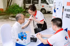 Nhân viên y tế đo huyết áp cho người dân tại Chương trình khám, tư vấn bệnh miễn phí. (Ảnh: PV/Vietnam+)