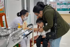 Phụ huynh đưa con đến tiêm vaccine phòng sởi tại Trung tâm Kiểm soát bệnh tật thành phố Đà Nẵng. (Ảnh: Văn Dũng/TTXVN)