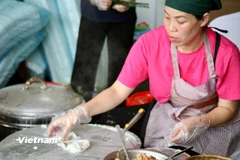 Gian hàng bánh cuốn Cao Bằng được tráng liên tục không ngơi tay để kịp phục vụ thực khách tại Hội chợ mùa Thu 2025. (Ảnh: Trịnh Huyền/Vietnam+)