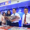 Ông Nguyễn Trọng Nghĩa, Ủy viên Bộ Chính trị, Bí thư Trung ương Đảng, Trưởng Ban Tuyên giáo và Dân vận Trung ương cùng các đại biểu tham quan gian trưng bày của Thông tấn xã Việt Nam tại Hội báo. (Ảnh: Hoài Nam/TTXVN)