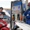 Khách hàng mua bán xăng, dầu tại một điểm kinh doanh xăng dầu của Petrolimex trên địa bàn Hà Nội. (Ảnh: Trần Việt /TTXVN)
