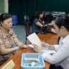 Thực hiện chi trả lương hưu, trợ cấp. (Ảnh: PV/Vietnam+)