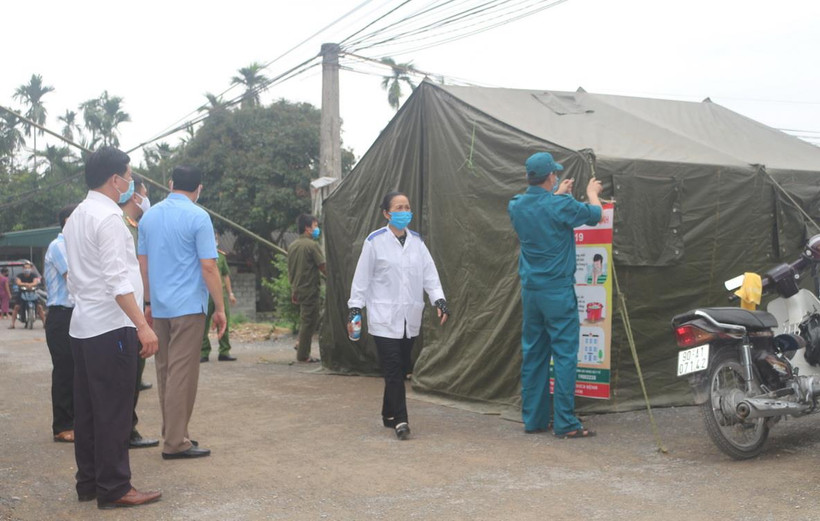 Các lực lượng chức năng tiến hành tháo dỡ các chốt kiểm soát phòng chống dịch Covid tại thôn 3 Ngô Khê. (Ảnh: Thanh Tuấn/TTXVN)