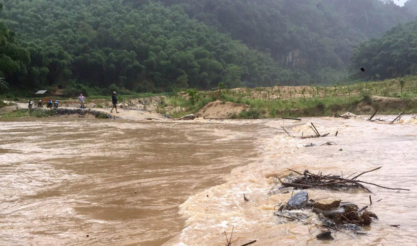 Nước sông dâng cao cuốn trôi đập tràn khiến giao thông bị chia cắt. (Ảnh: TTXVN phát)