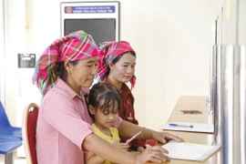 Đồng bào dân tộc Hà Nhì làm thủ tục tại Trung tâm phục vụ hành chính công xã biên giới Sín Thầu, tỉnh Điện Biên. (Ảnh: Trung Kiên/TTXVN)