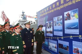 Đại tướng Phan Văn Giang và Thượng tướng Đổng Quân xem một số hình ảnh về 20 năm tuần tra liên hợp trên vùng biển Vịnh Bắc bộ giữa Hải quân hai nước. (Ảnh: Trọng Đức/TTXVN)