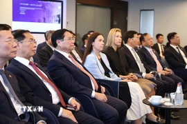 Thủ tướng Phạm Minh Chính nghe giới thiệu về Trung tâm E-Estonia Briefing Centre. (Ảnh: Dương Giang/TTXVN)