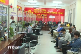 Cán bộ, công chức xã Bà Điểm (Thành phố Hồ Chí Minh) làm việc xuyên trưa giải quyết hồ sơ hành chính phục vụ người dân. (Ảnh: Hữu Duyên/TTXVN)