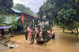 Công an Thanh Hóa tổ chức di dời tài sản và 10 hộ dân tại thôn Quyết Thắng 1 đến nơi an toàn. (Ảnh: TTXVN phát)