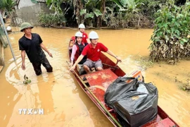 Đoàn công tác của Trung ương Hội Chữ thập Đỏ Việt Nam vượt qua những tuyến đường ngập lụt, mang hàng cứu trợ khẩn cấp đến với người dân xã Nhân Hòa (Nghệ An) - nơi đang chịu thiệt hại nặng nề do hoàn lưu bão số 3 (Wipha). (Ảnh: TTXVN phát)
